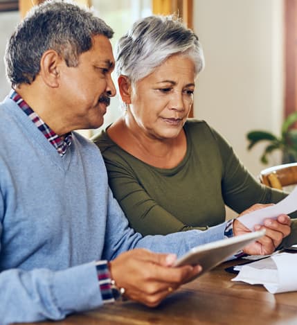 Couple reviewing enrollment documents with an insurance agent